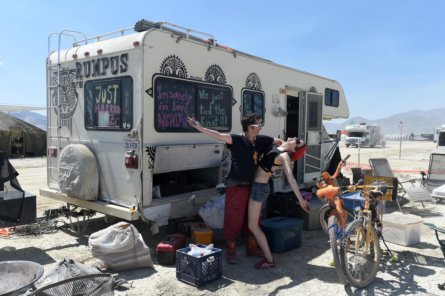Eric Peltier and Martha Lackritz celebrate their honeymoon at the Burning Man event on the Black Rock Desert in Gerlach, Nev., on Aug. 24, 2014, a day before the event opens to ticket holders. (AP Pho ...