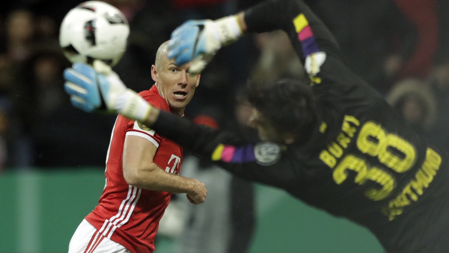 Bayern&#039;s Arjen Robben tries to score in front of Dortmund goalkeeper Roman Buerki during the German Soccer Cup semifinal match between FC Bayern Munich and Borussia Dortmund at the Allianz Arena  ...