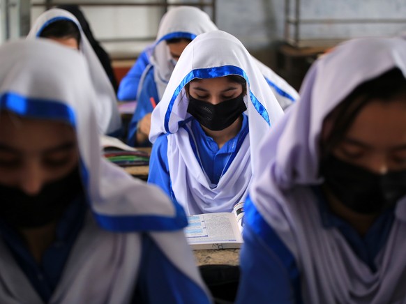 epa09586787 Pakistani girls do school work during International Student Day, in Peshawar, Pakistan, 17 November 2021. International Student Day is observed on 17 November across the world, with this y ...