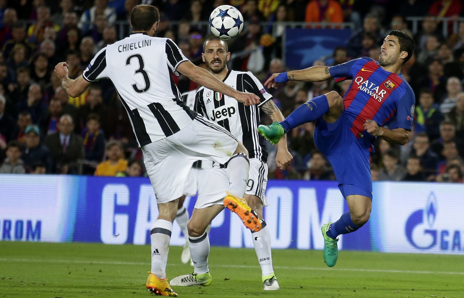 Barcelona&#039;s Luis Suarez, right, challenges Juventus&#039;s Giorgio Chiellini, left, and Juventus&#039;s Leonardo Bonucci, center, during the Champions League quarterfinal second leg soccer match  ...