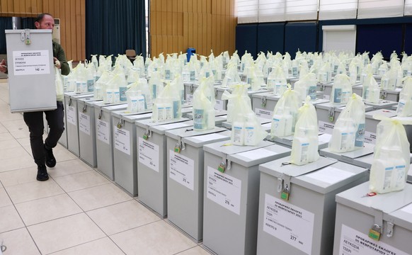 epaselect epa10445190 Polling station officials take a delivery of ballot boxes for the upcoming Cypriot presidential elections in Nicosia, Cyprus, 03 February 2023. Cyprus is to hold presidential ele ...