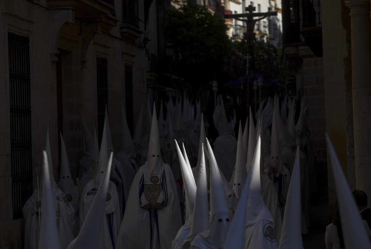 Hooded penitents from "La Sed" brotherhood take part in a procession in Jerez de la Frontera, Cadiz province in Andalucia, southern Spain, Monday, April 15, 2019. Hundreds of processions tak ...