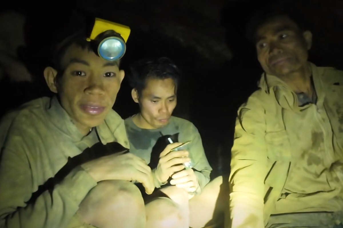 This image made from the video provided by Benz Norrased Palasing Seascout Diving shows the villagers who were trapped and found in a flooded cave in Xaisomboun province, Laos, Wednesday, May 27, 2026 ...