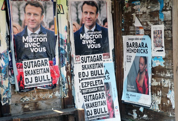 Posters of French President Emmanuel Macron and centrist candidate for reelection in Saint Pee sur Nivelle, southwestern France, Wednesday, March 23, 2022. The two-round presidential election will tak ...