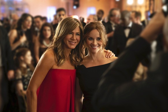 This image released by Apple TV Plus, Jennifer Aniston, left, and Reese Witherspoon appear in a scene from &quot;The Morning Show,&quot; behind-the-scenes look at fictional players in the competitive  ...