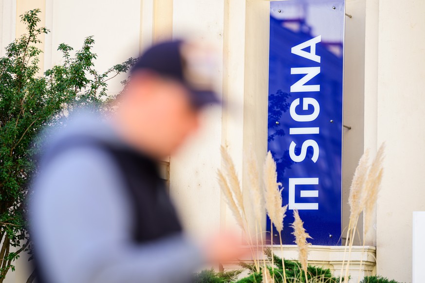 epa10964336 A man passes by a logo of Austrian real estate and trading company Signa Holding at the group&#039;s Vienna office, in Vienna, Austria, 08 November 2023. Rene Benko, Austrian business man  ...