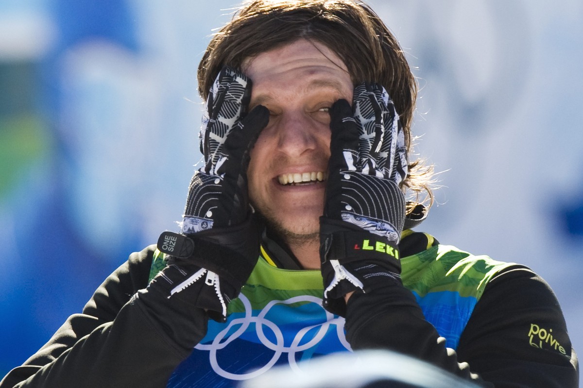 Switzerland's freestyle skier Michael Schmid, celebrates winning the gold medal during the flower ceremony after the final of men's ski freestyle cross competition at the XXI Olympic Winter  ...