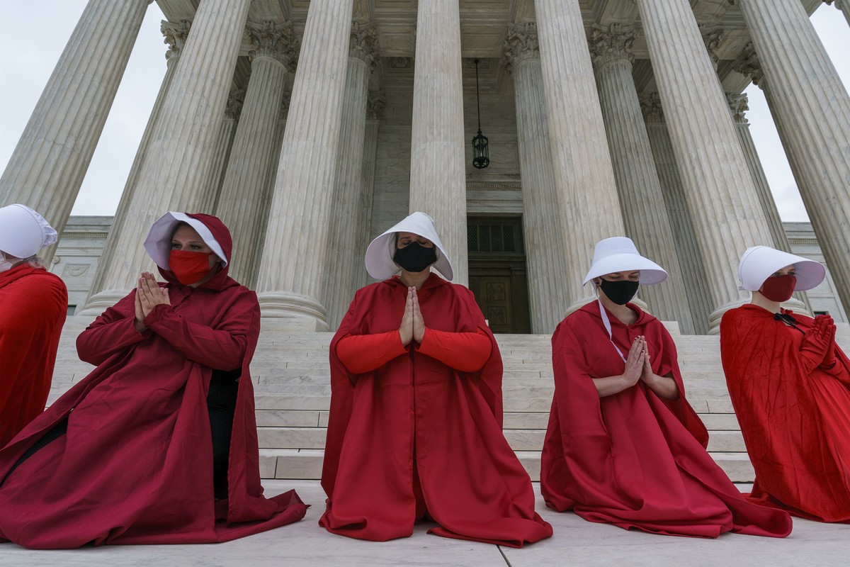 Activists opposed to the confirmation of President Donald Trump's Supreme Court nominee, Judge Amy Coney Barrett, are dressed as characters from "The Handmaid's Tale," at the Supre ...