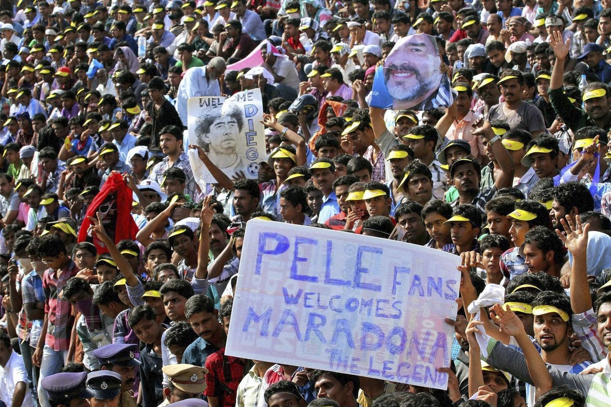 In this Wednesday, Oct. 24, 2012 photo, fans crowd a stadium for a glimpse of Argentina soccer legend Diego Maradona, in Kannur, Kerala, India. Maradona enthralled thousands of fans during his two-day ...
