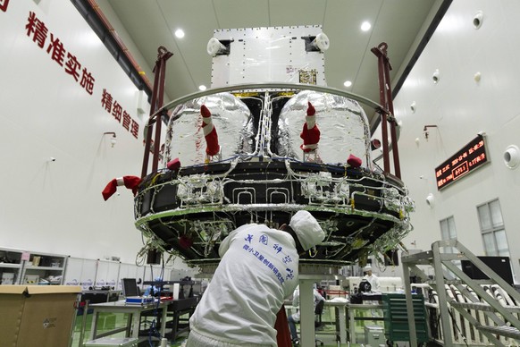 241105 -- SHANGHAI, Nov. 5, 2024 -- A technician checks the Solar wind Magnetosphere Ionosphere Link Explorer SMILE at a workshop of the Innovation Academy for Microsatellites of Chinese Academy of Sc ...