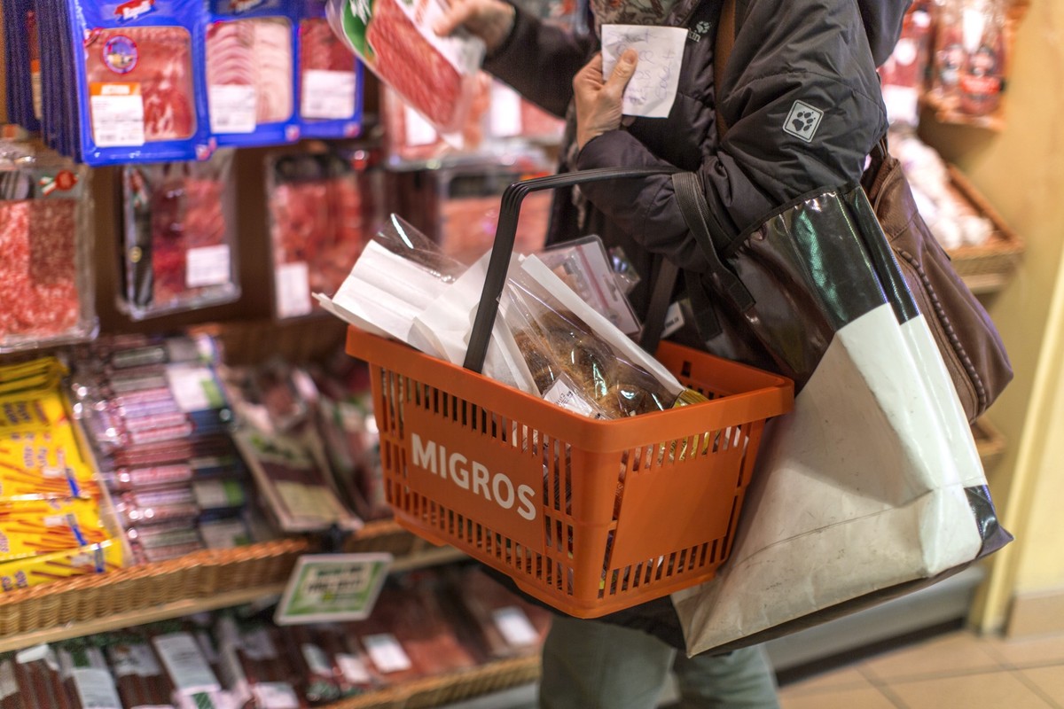 A customer with a shopping basket takes a meat product from the shelf, pictured on March 5, 2013, at the Migros branch in Baden, Switzerland. Migros is Switzerland's the largest retail company. ( ...