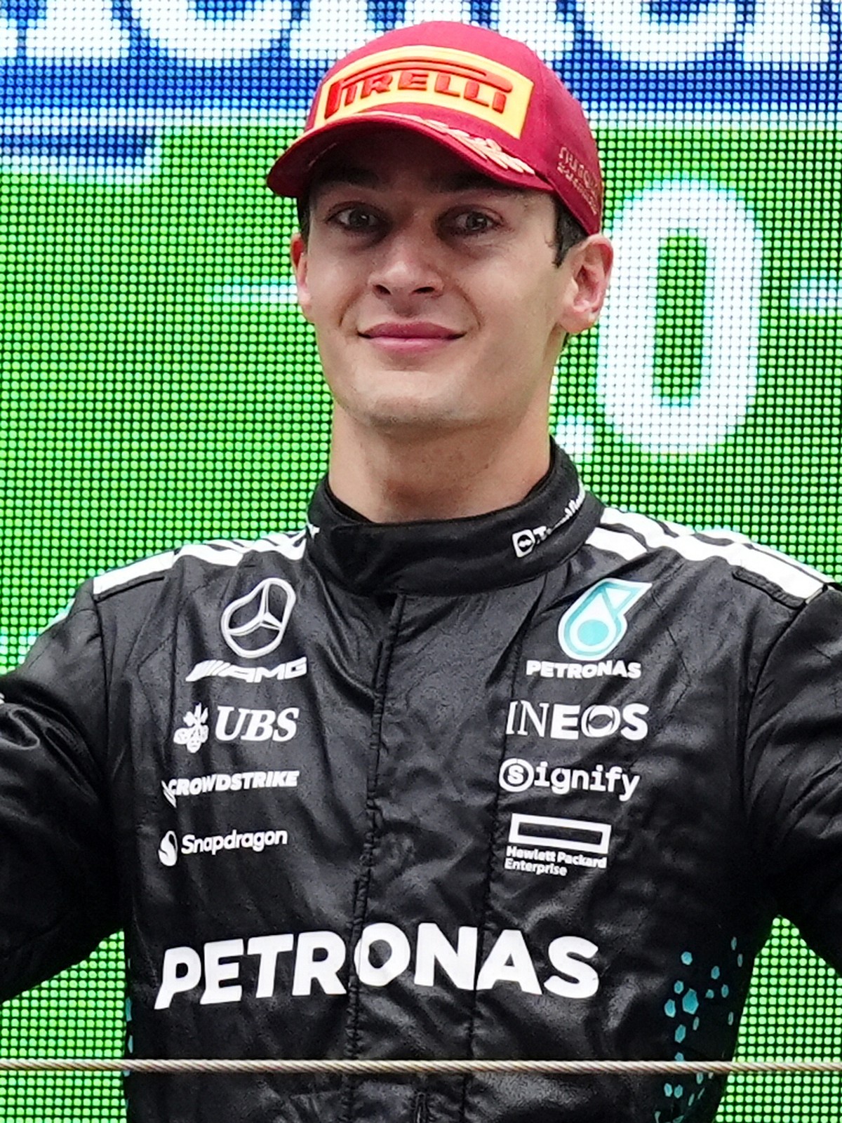 Mercedes driver George Russell of Britain celebrates on the podium after placing third in the Chinese Formula One Grand Prix race at the Shanghai International Circuit, Shanghai, Sunday, March 23, 202 ...