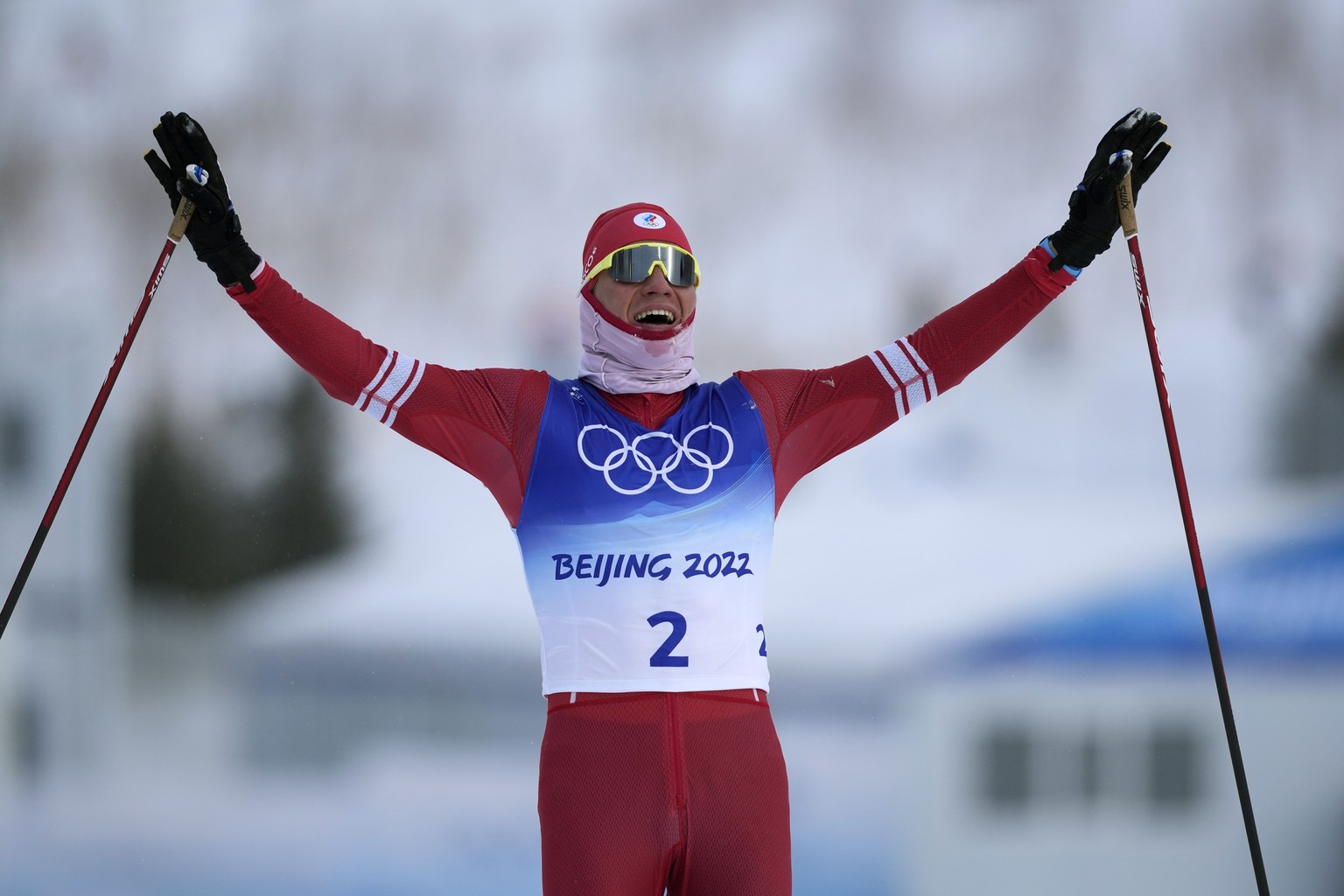 Russian athlete Alexander Bolshunov reacts as he crosses the finish line during the men&#039;s weather-shortened 50km mass start free cross-country skiing competition at the 2022 Winter Olympics, Satu ...