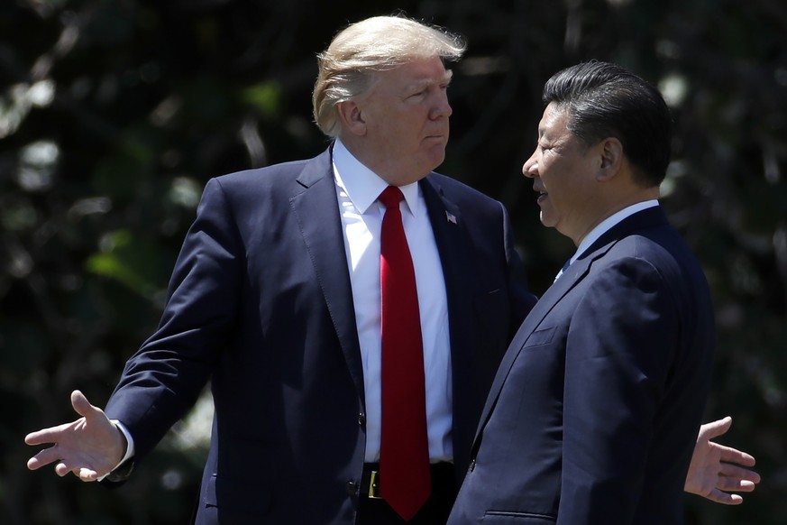 FILE - In this April 7, 2017, file photo, U.S. President Donald Trump gestures as he and Chinese President Xi Jinping walk together after their meetings at Mar-a-Lago, in Palm Beach, Fla. Trump starte ...