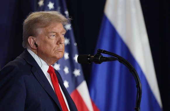 epa12303736 US President Donald Trump listens to Russian President Vladimir Putin during a joint news conference following their meeting at Joint Base Elmendorf-Richardson in Anchorage, Alaska, USA, 1 ...