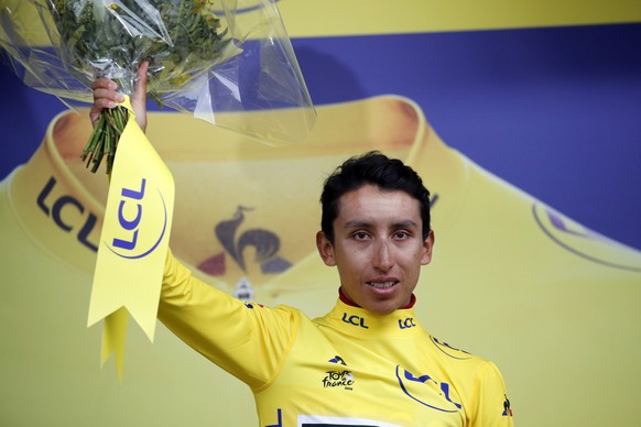 New overall leader Colombia's Egan Arley Bernal Gomez wearing the yellow jersey celebrates on the podium after the nineteenth stage of the Tour de France cycling race with start in Saint Jean De ...