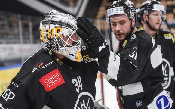 From left, Lugano?s goalkeeper Niklas Schlegel and Lugano?s player Elia Riva disappointed at the end of the match, during the fifth leg of the playoff best of seven match of the Swiss National League  ...