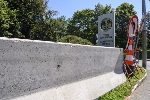 Road signs and concrete retaining walls in front of the logo of the World Council of Churches, WCC, where Pope Francis will give a mass tomorrow, on the occasion of an ecumenical pilgrimage to the 70t ...