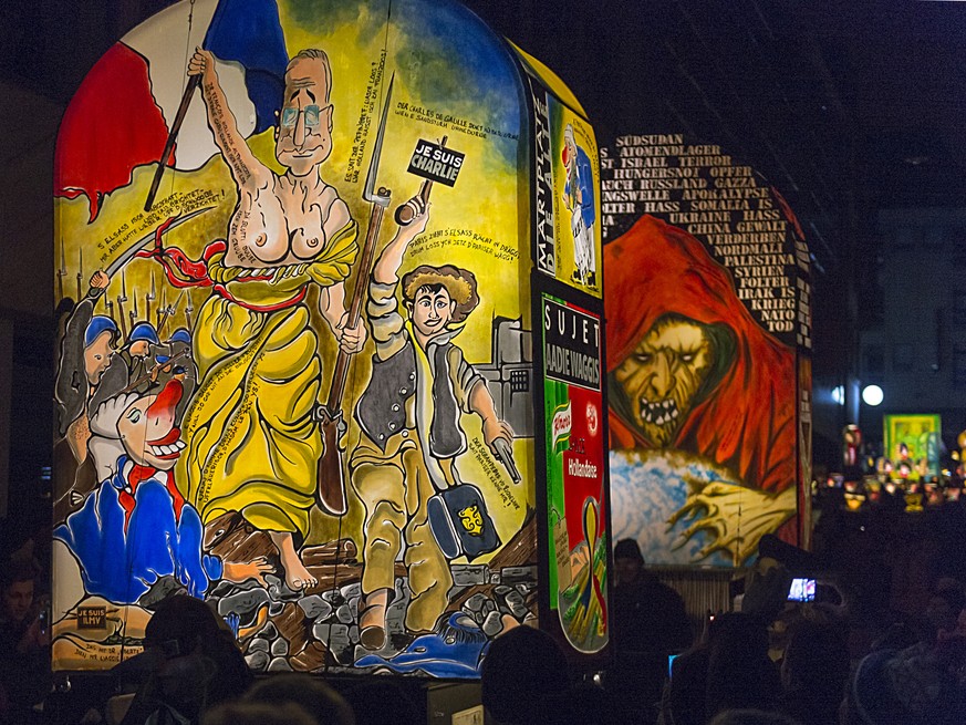 Revellers wearing lanterns parade through the streets at the carnival procession of Basel, Switzerland, Monday morning, February 23, 2015. The traditional &quot;Morgestraich&quot; starting at 4 a.m. i ...