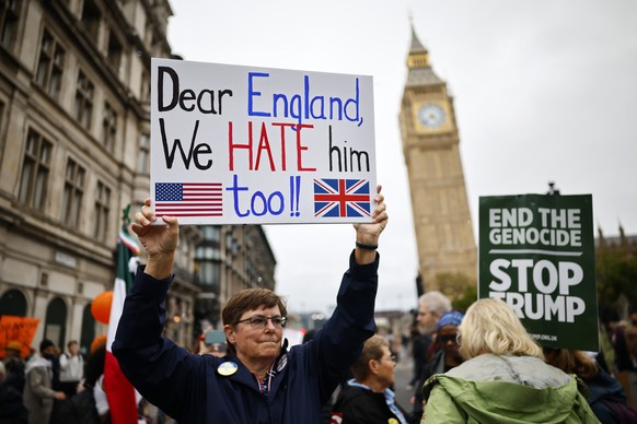 epa12385185 A protester holds up a placard during a &#039;Stop Trump Coalition&#039; mass demonstration against the state visit to the UK by US President Donald J Trump in London, Britain, 17 Septembe ...
