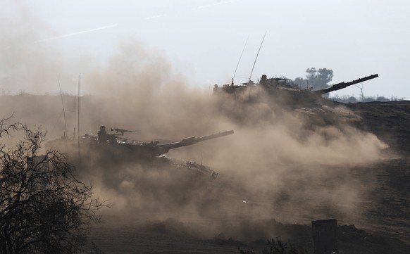 epa09368262 Israeli Merkava 4 tanks are seen during a military training in the Golan Heights, next to the Israeli -Syrian border, 26 July 2021. Israeli Defense Minister Gantz said during his party mee ...