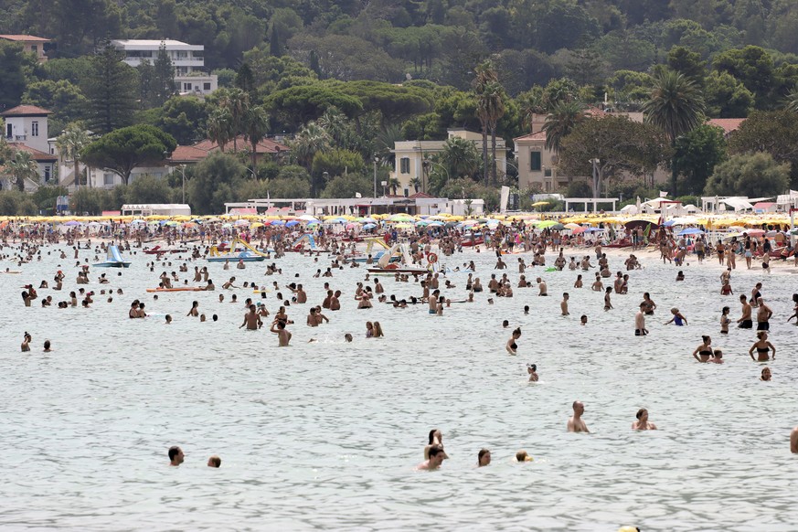 People refresh in the sea in Palermo, Sicily, Italy, Wednesday, Aug. 11, 2021. The ongoing heatwave will last up until the weekend with temperatures expected to reach well over 40 degrees Celsius in m ...
