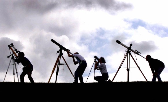 FILE - Members of the British Astronomers Association prepare their telescopes Tuesday, Aug. 10, 1999, at their campsite near Truro, England. The group is preparing for a total solar eclipse which wil ...