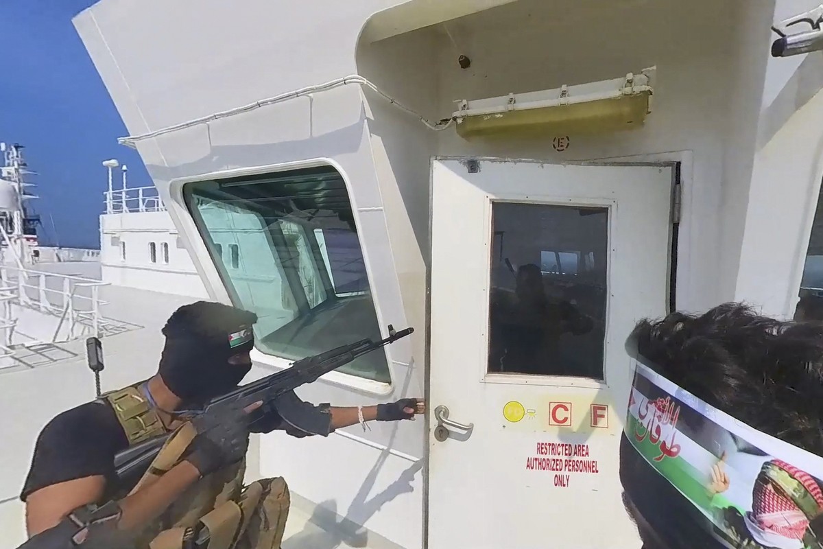 This photo released by the Houthi Media Center shows Houthi forces boarding the cargo ship Galaxy Leader on Sunday, Nov. 19, 2023. Yemen's Houthis have seized the ship in the Red Sea off the coas ...
