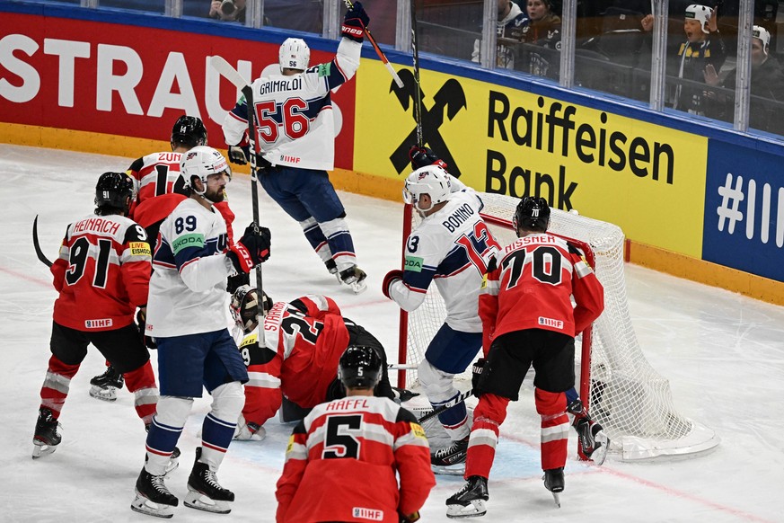 epa10634186 Rocco Grimaldi (top) from USA .celebrates a goal during the IIHF 2023 Ice Hockey World Championship group A match between USA and Austria in Tampere, Finland, 17 May 2023. EPA/KIMMO BRANDT