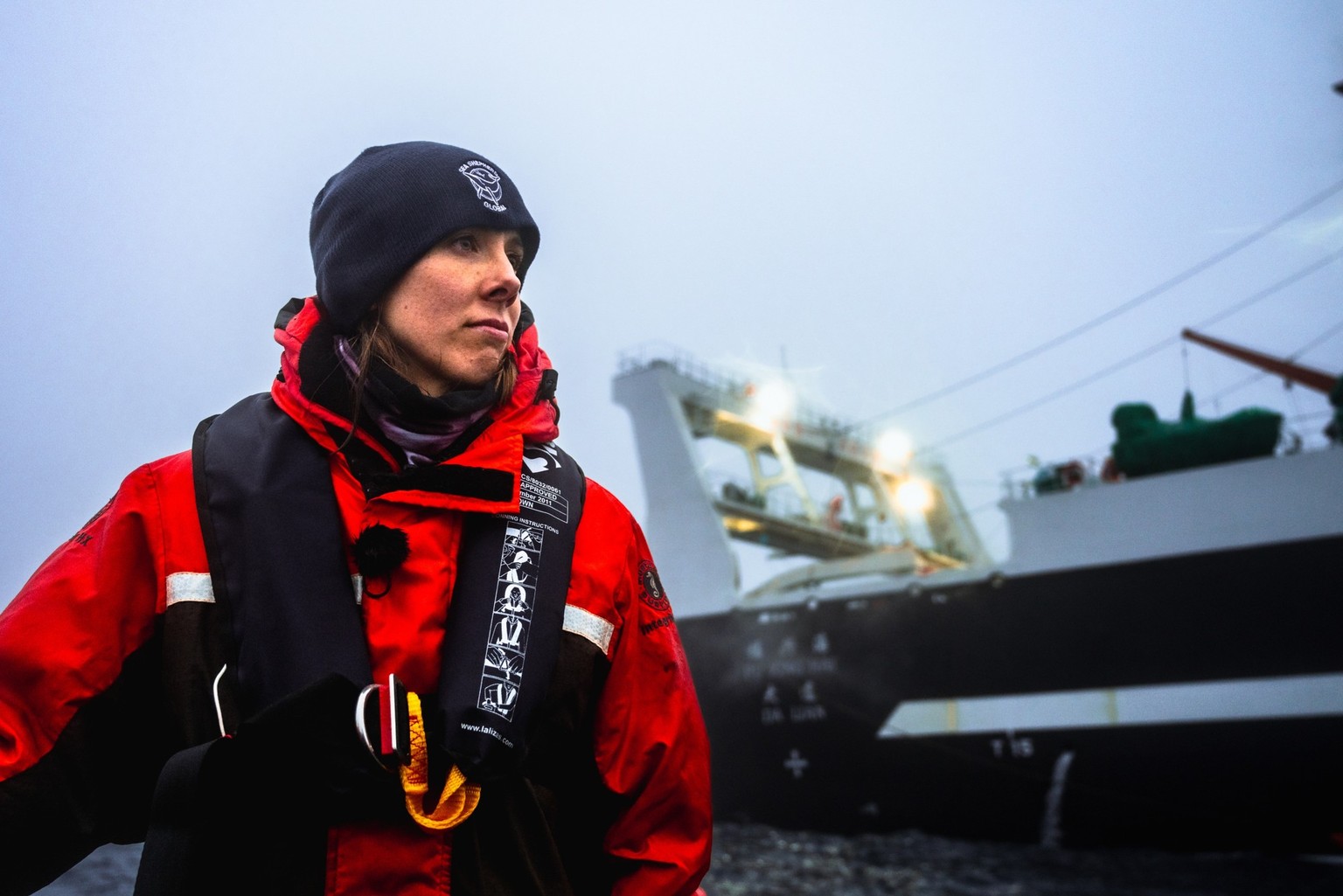 240207-OAD2-YK-Sea shepherd crew Franziska outside in front of krill fishing boat Fu xing hai da lian-DSC_1746