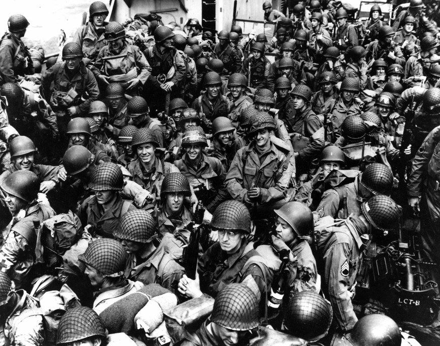 Army troops on board a LCT, ready to ride across the English Channel to France to take part in the Allied invasion of German-occupied France. Some of these men wear 101st Airborne Division insignia. P ...
