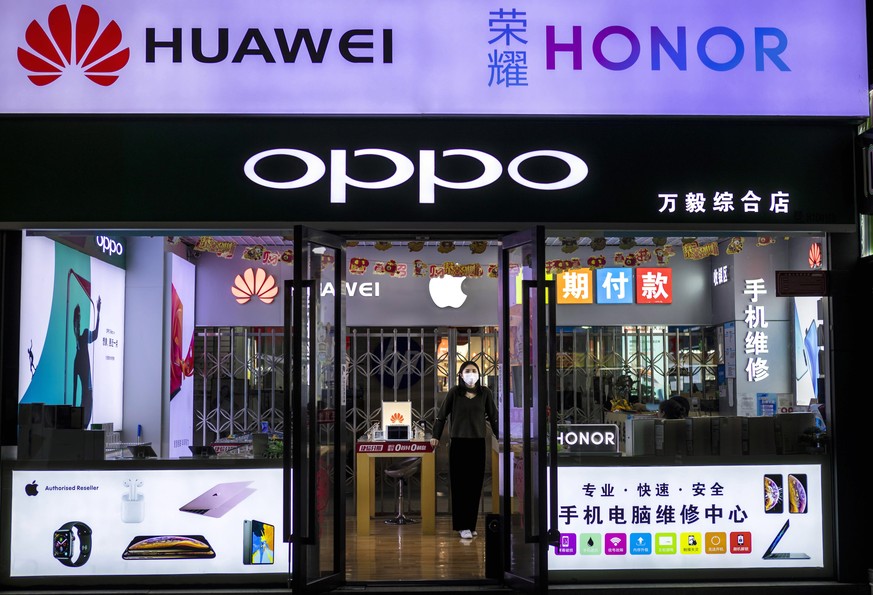 epa08296717 A woman stands in a shop within the Shenzhen Electronics Market in Shenzhen, Guangdong province, China, 13 March 2020 (issued 16 March 2020). China&#039;s value-added industrial output, an ...