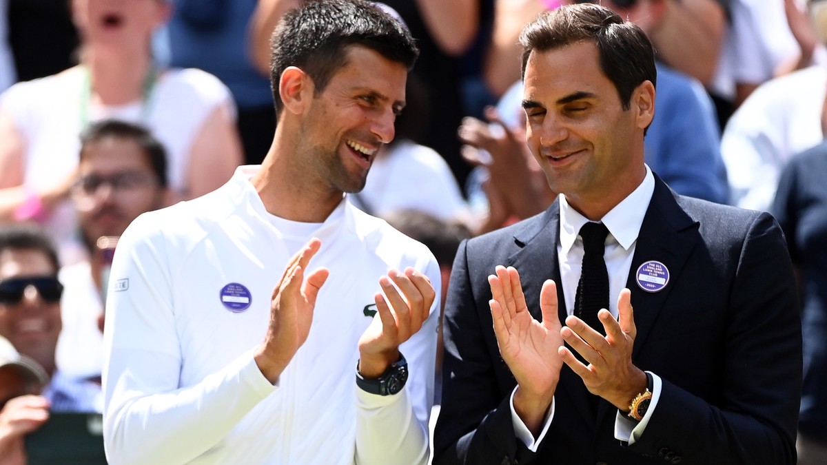 epa10049481 Novak Djokovic (L) of Serbia and Roger Federer (R) of Switzerland attend an event to celebrate the 100th anniversary of the Centre Court ahead of the women's 4th round match between H ...