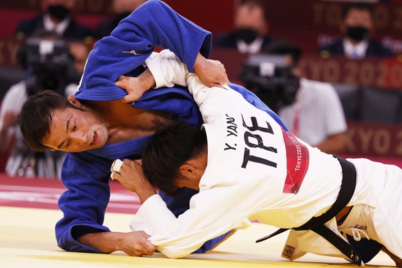 epa09361680 Naohisa Takato (blue) of Japan in action against Yung-wei Yang (white) of Chinese Taipei during their bout in the Men -60 kg Final at Judo competitions of the Tokyo 2020 Olympic Games at t ...