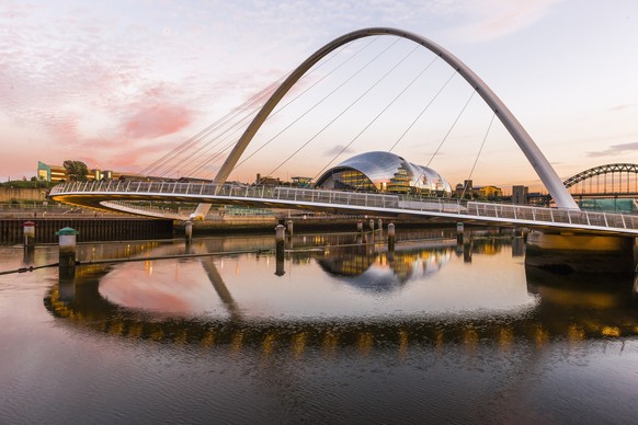 The Gateshead Millennium Bridge (Keith Brownlie, Wilkinson Eyre Architects) between Gateshead and Newcastle upon Tyne and the River Tyne at sunset, the Sage Gateshead (Norman Foster architect) at ...