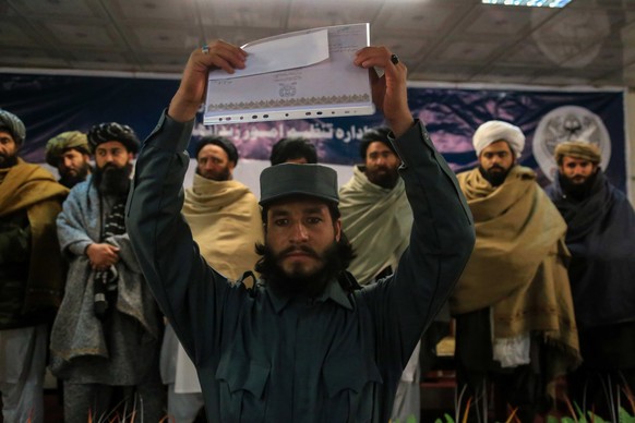 epa09712853 Taliban prison police attend their graduation ceremony in Kabul, Afghanistan, 27 January 2022. Some 212 Taliban have graduated after a month-long course to be stationed at prison security  ...