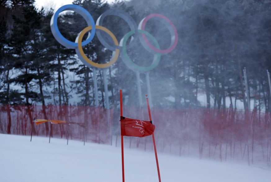 Snow blows across the course as a gate billows in the wind after the women&#039;s giant slalom was postponed due to high winds at the 2018 Winter Olympics at the Yongpyong Alpine Center, Pyeongchang,  ...