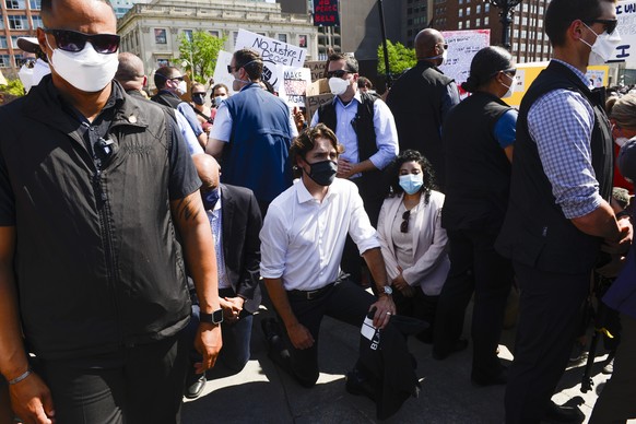 Prime Minister Justin Trudeau takes a knee as he takes part in an anti-racism protest on Parliament Hill during the COVID-19 pandemic in Ottawa, Friday, June 5, 2020. The death of George Floyd, a blac ...