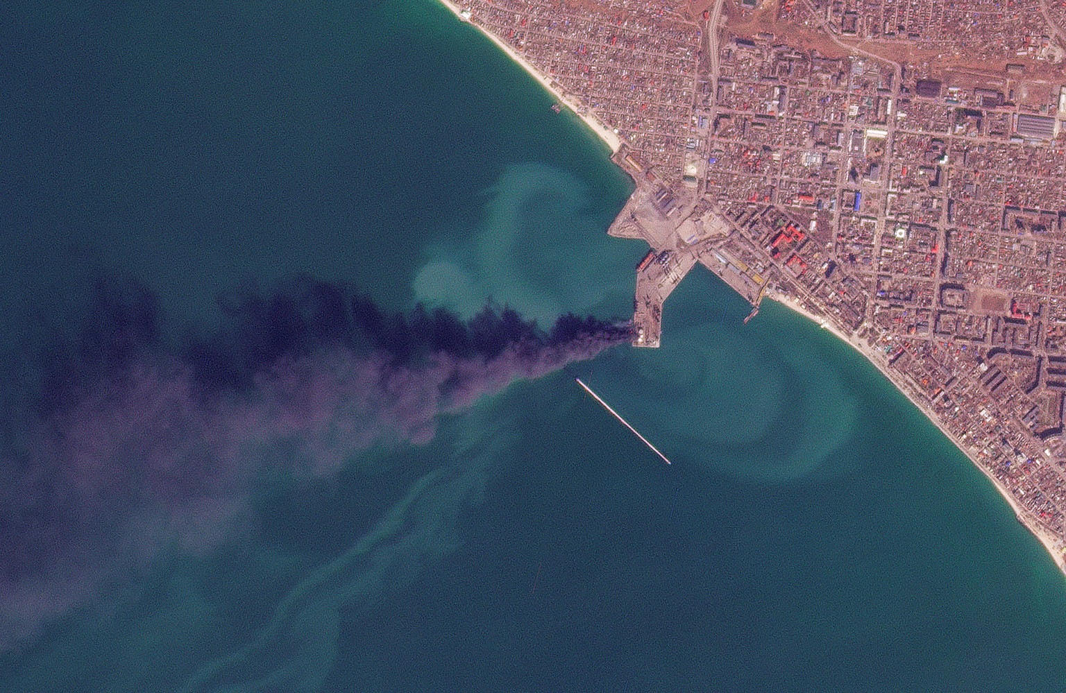 In this satellite photo from Planet Labs PBC, smoke rises after an attack that Ukraine&#039;s navy said sank a large Russian landing ship in the port city of Berdyansk, Ukraine, Thursday, March 24, 20 ...