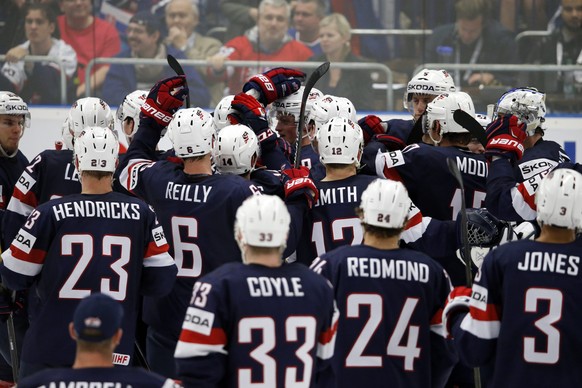 epa04744992 Players of the USA celebrate their victory after scoring a golden goal at the Ice Hockey World Championship 2015 group B match between the USA and Slovakia at CEZ Arena in Ostrava, Czech R ...