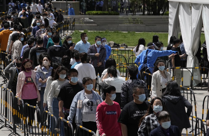 Residents line up for COVID mass testing near tents set up at a plaza in the Haidian district on Tuesday, April 26, 2022, in Beijing. China&#039;s capital Beijing is enforcing mass testing and closing ...