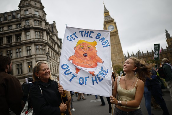 epa12385137 Protesters hold up a depiction of the &#039;Baby Trump Blimp&#039; during a &#039;Stop Trump Coalition&#039; mass demonstration against the state visit to the UK by US President Donald J T ...