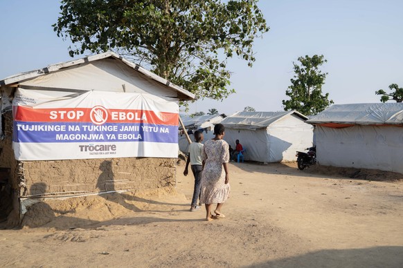 epa13189624 A woman walks past a poster about Ebola prevention in Mambasa, Ituri, Democratic Republic of Congo, 24 August 2026. The Ebola outbreak has reached Mambasa, where the local branch of the No ...