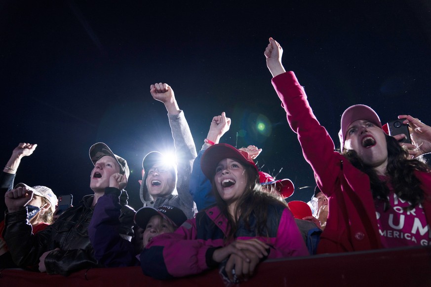 Supporters of President Donald Trump cheer as he arrives for a campaign rally at Richard B. Russell Airport, Sunday, Nov. 1, 2020, in Rome, Ga. (AP Photo/Evan Vucci) ]
Donald Trump