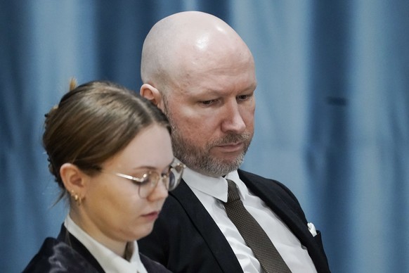 Anders Behring Breivik and attorney Marte Lindholm sits, as the Oslo district court conducts his case in a gymnasium at Ringerike prison, in Ringerike, Norway, Monday, Jan. 8, 2024. Breivik, who slaye ...