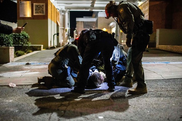 KEYPIX - Law enforcement officers arrest a protester near a U.S. Immigration and Customs Enforcement facility in Portland, Ore. on Sunday, October. 5, 2025. (AP Photo/Ethan Swope)