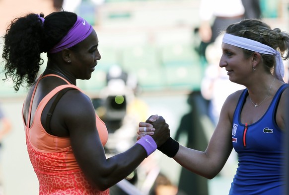 epa04783369 Serena Williams of the USA (L) shakes hands withTimea Bacsinszky of Switzerland after their semifinal match for the French Open tennis tournament at Roland Garros in Paris, France, 04 June ...