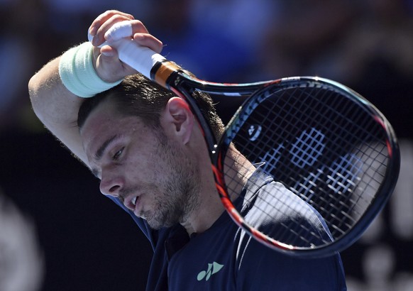 Switzerland&#039;s Stan Wawrinka wipes the sweat from face as he plays Lithuania&#039;s Ricardas Berankis during their first round match at the Australian Open tennis championships in Melbourne, Austr ...