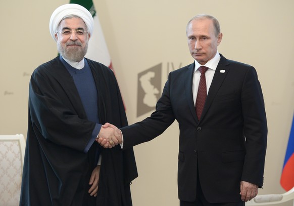 President of Iran Hassan Ruhani, left, and Russian President Vladimir Putin shake hands during their meeting at the Caspian Summit in Astrakhan, Russia, Monday, Sept. 29, 2014. (AP Photo/RIA Novosti,  ...