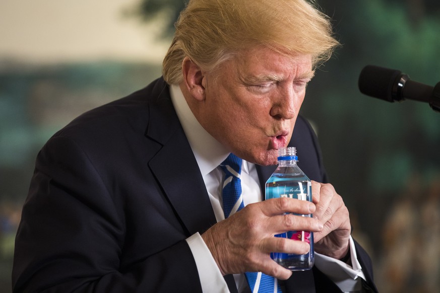 epa08939597 (FILE) US President Donald J. Trump pauses to drink water while touting his foreign policy accomplishments during his trip to Asia in a speech in the Diplomatic Room at the White House in ...